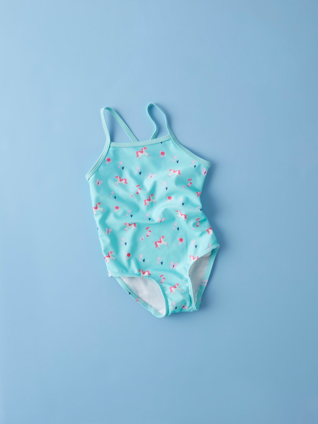 bañador de niña Name It color turquesa con unicornios tirantes cruzados Koskids