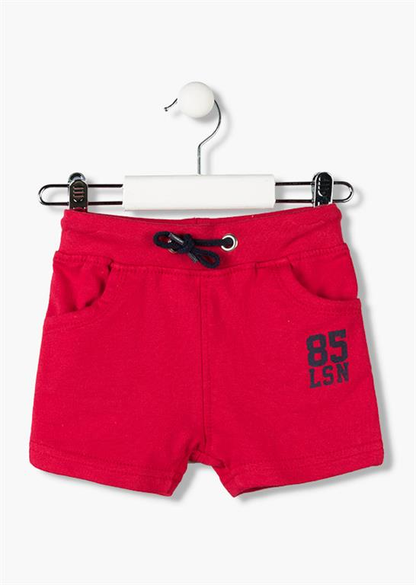 Bermudas tipo chandal de bebé con cinturilla ajustable con goma y cordones en color rojo con letras oscuras en la pierna Losan